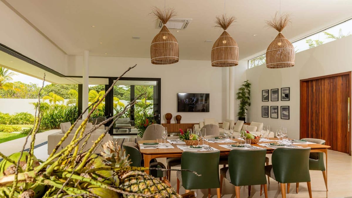 Sala de jantar e estar integradas com vista para o jardim